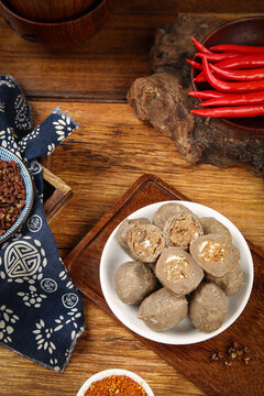 Delicious Traditional Teochew Beef Balls Handmade Chinese Meatballs with Spices and Chilies on Rustic Wooden Table