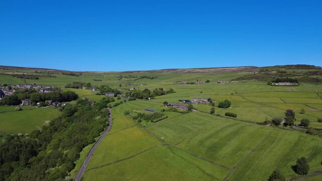 High panoramic view of West yorkshire Landscape in summer showing Sandy Gate Lane and the hamlet of Old Town near Hebden Bridge with meadows surrounding farmhouses