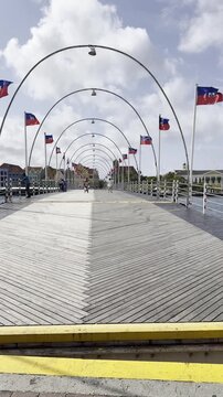 People clearing the Queen Emma pontoon bridge right before it opens in Willemstad, Curacao.