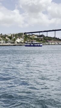 Description: Water taxi operating while the Queen Emma pontoon bridge is open in Willemstad, Curacao.