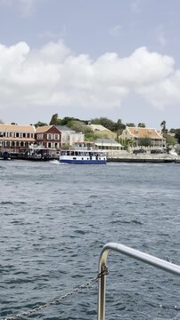 Public water taxi navigating the water channel in Willemstad, Curacao, during pontoon bridge closure.