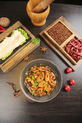 Fototapeta premium Traditional Asian Sautéed Pork Intestine with Spicy Peppers and Cooking Ingredients