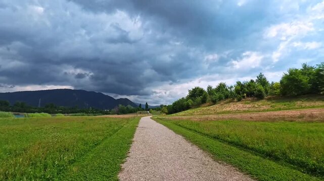 Walking Through Windy Countryside Path Beneath Dramatic Mountain Clouds, Brescia, Italy - POV VIDEO
