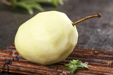 Fresh Peeled Green Pear from Pucheng Shaanxi China on Bamboo Mat with Mint Leaf © BuiThi