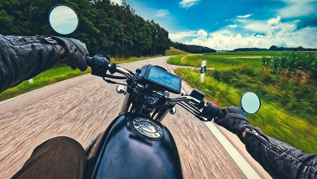 Riding classic retro motorcycle  naked bike on land road curves on sunny summer day - POV handlebar forward view in motion