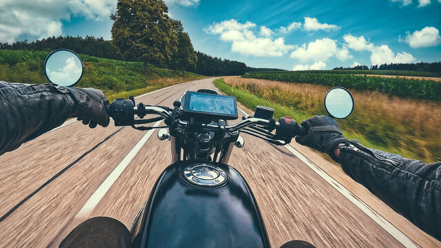 Riding classic retro motorcycle  naked bike on land road curves - POV handlebar forward view in motion