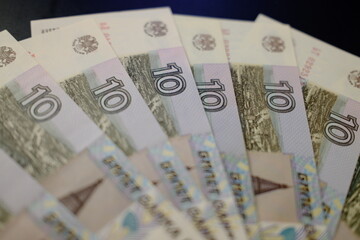 Obraz premium Close-up of Russian 10 rouble banknotes, top view. Stack of ten rouble banknotes, macro top view