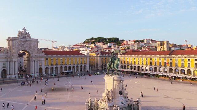 Lisbon City at Sunset. Commerce Plaza, Equestrian Statue, Tourists and Rua Augusta Arch. Portugal. Aerial Drone Shot. Moving Forward and Upwards