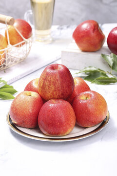 Fresh Red Delicious Apples on Plate with Refreshing Fruit Juice - Healthy Food Photography