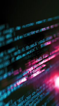 Code text editor screen glow neon blue pink dark vertical composition of glowing code text on dark screen with blue and pink light cyber style blurred focus