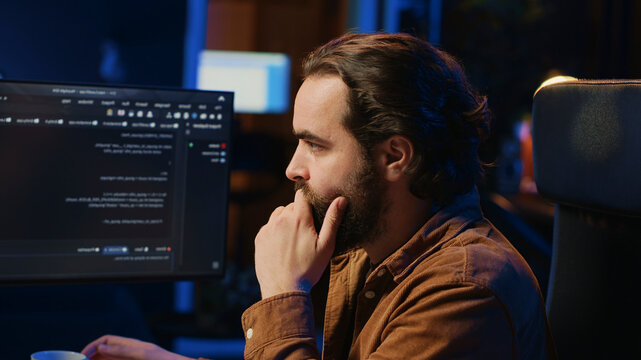 Computer scientist drinking cup of coffee while developing code on PC using java programming languages, IT admin brainstorming ways of fixing database errors, enjoying hot beverage.