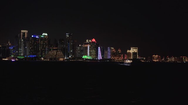 Night view of the illuminated West Bay skyline and Sheraton Grand Doha.