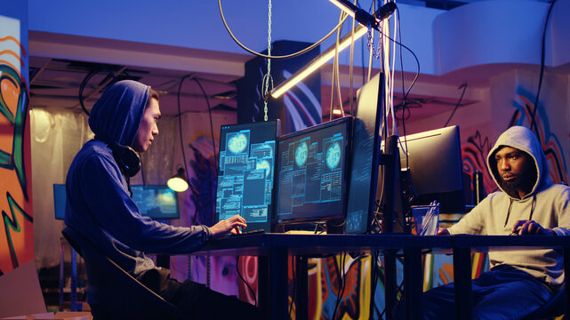 Hackers in hidden shelter excited after managing to launch successful DDoS attack on website, celebrating being able to it crash by sending large amounts of traffic from multiple sources.