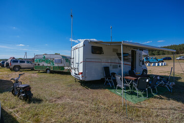 Fototapeta premium Caravan trailer on wheels in summer day camping