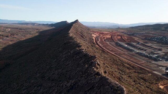 Aerial Drone View Rising Over Utah Desert Bluff with Red Rocks and Sand Dunes