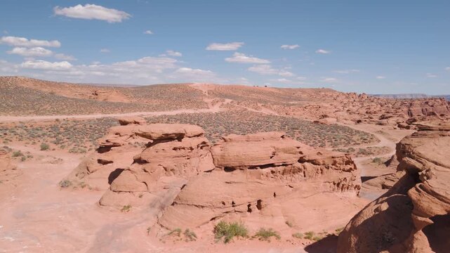 Aerial Drone View Rising Over Utah Desert Bluff with Red Rocks and Sand Dunes