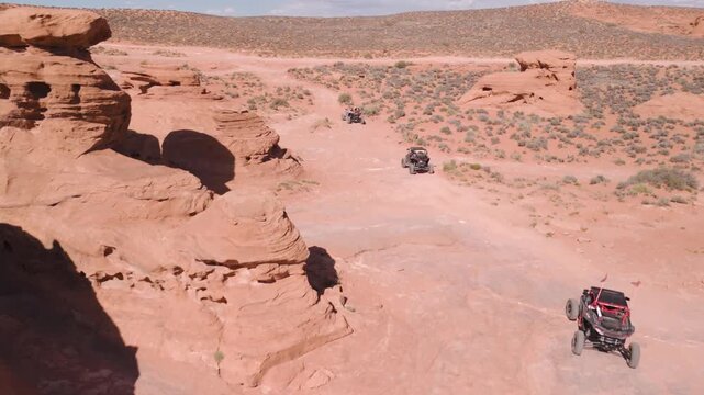 Aerial Drone View of UTVs Offroading on Red Rock Desert Trails in Utah