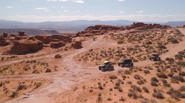 Aerial Drone View of UTVs Offroading on Red Rock Desert Trails in Utah