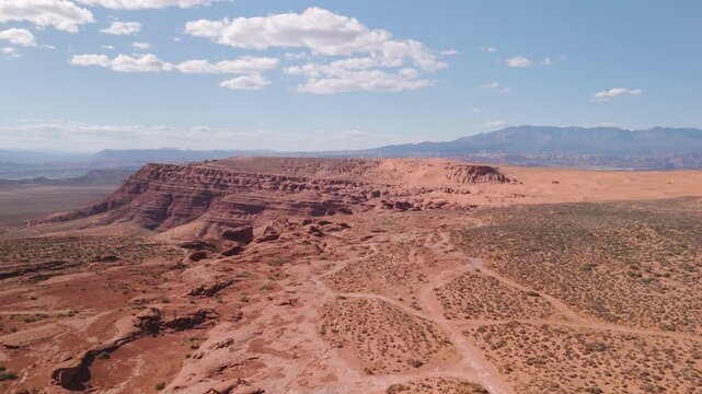 Aerial Drone View Rising Over Utah Desert Bluff with Red Rocks and Sand Dunes