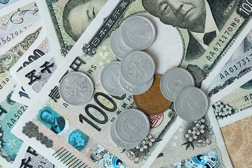 Japanese yen money bills and coins on table. Japan cash of JPY currency close up © Larysa