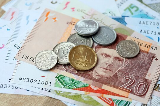 Pakistani rupee money bills and coins on table. Pakistan cash of PKR currency close up