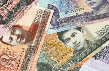 Cambodian riel money bills in pile on table. Cambodia KHR currency cash close up © Viktor