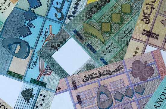 Lebanese pound money bills in pile on table. Lebanon LBP currency cash close up