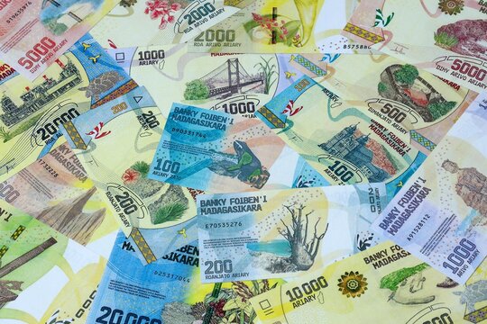 Malagasy ariary money bills in pile on table. Madagascar MGA currency cash close up