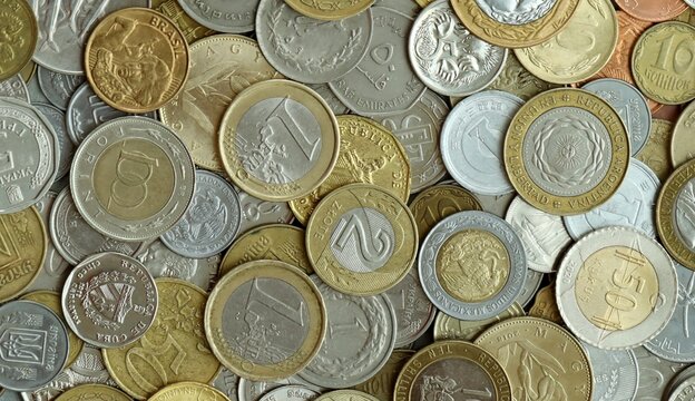 Big pile of coins from different money currencies. Treasure and numismatics concept