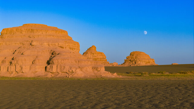 Moon over yardang desert landforms in Dunhuang, Gansu, China