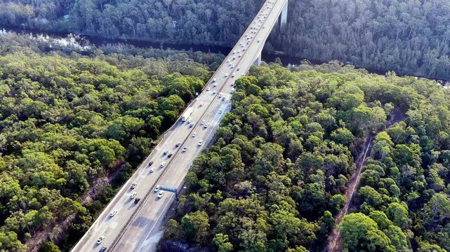 Back aerial flying over Motorway one holiday traffic jam in Australia heavy use of road.