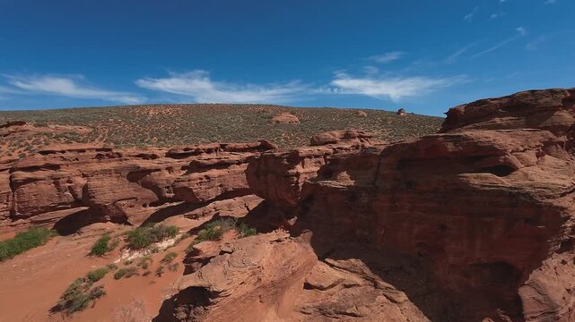 FPV Drone Cinematic Flight Around Desert Rock Pillars with UTVs and People Camping