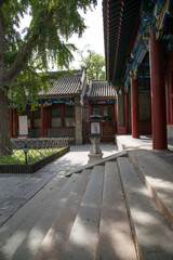 Fototapeta premium Traditional Chinese courtyard temple architecture with red columns and stone steps