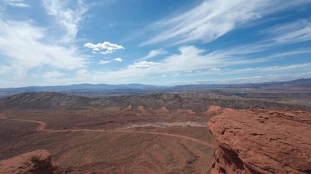 FPV Drone Cinematic Flight Around Desert Rock Pillars with UTVs and People Camping