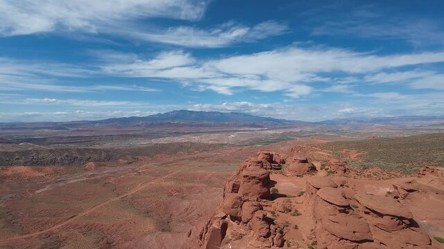 FPV Drone Cinematic Flight Around Desert Rock Pillars with UTVs and People Camping