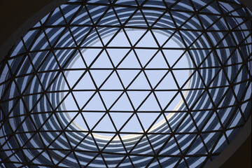 Geometric glass dome skylight with circular atrium in modern architecture © PhamThi