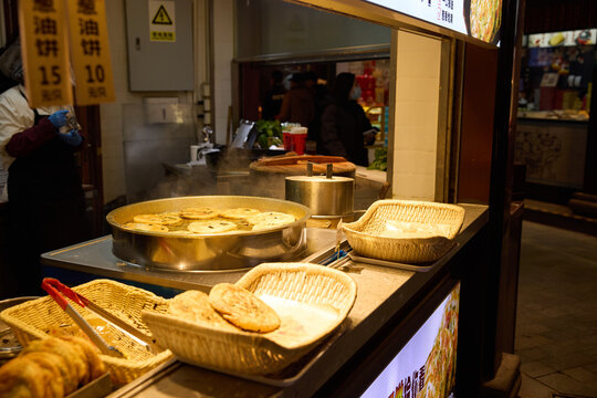 Steaming scallion pancakes at a Chinese street food stall