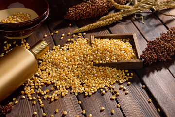 Dried corn kernels with wooden scoop on rustic wooden table © TranVan