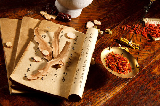 Traditional Chinese Herbal Medicine with Dried Herbs, Scroll and Balance Scale