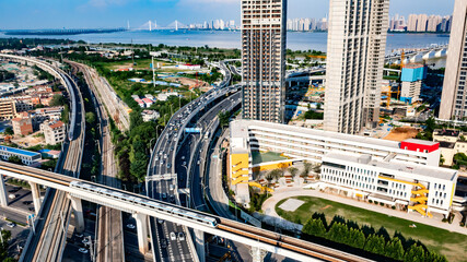 Aerial view of Wuhan riverside skyline with elevated metro, expressways and school campus © NguyenMinh