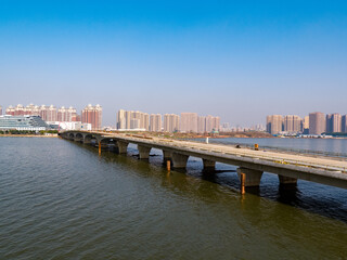 Fototapeta premium Bridge across South Lake with Wuhan city skyline, China