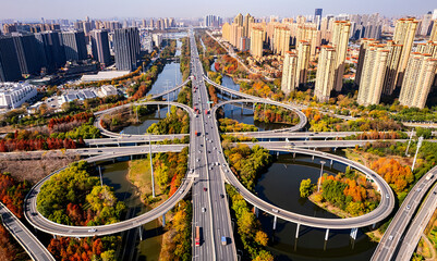 Aerial view of Wuhan Third Ring Road interchange with autumn foliage and urban skyline, China © NguyenMinh