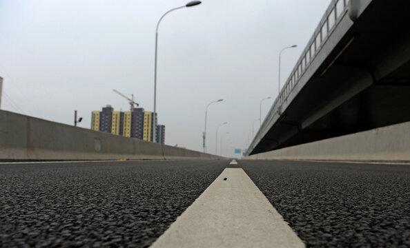 Empty urban road and elevated overpass in a modern city