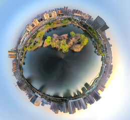 Tiny planet aerial view of urban lake island and modern city skyline © HoangNgoc