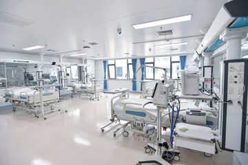 Fototapeta premium Modern hospital intensive care unit ward interior with beds and medical equipment