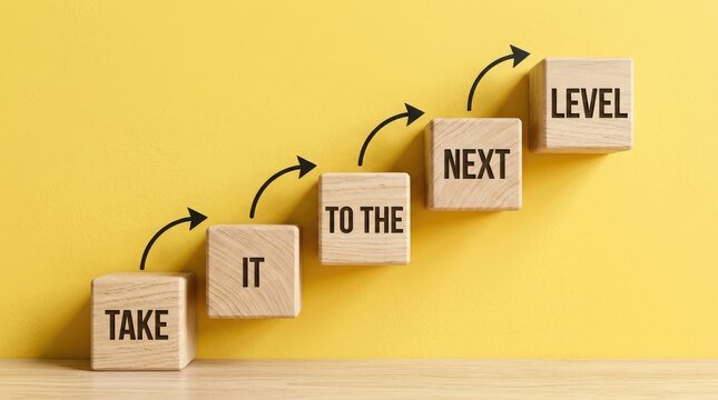 Wooden blocks stacked in a staircase formation with black text reading take it to the next level on yellow background