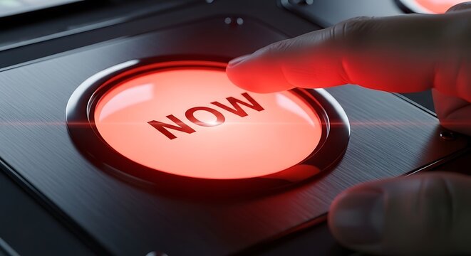Human finger pressing a glowing red button with the urgent word NOW