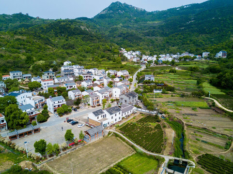 Aerial Village in Green Mountain Valley with Surrounding Agricultural Fields