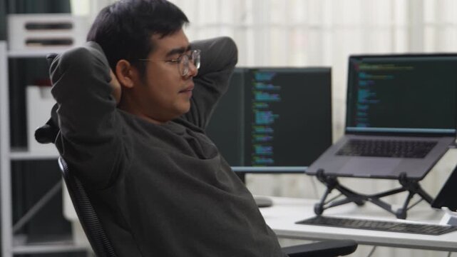 Professional Developer Taking a Moment to Stretch During Remote Working