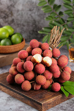 Fresh Lychee Fruits on Wooden Board with Lime